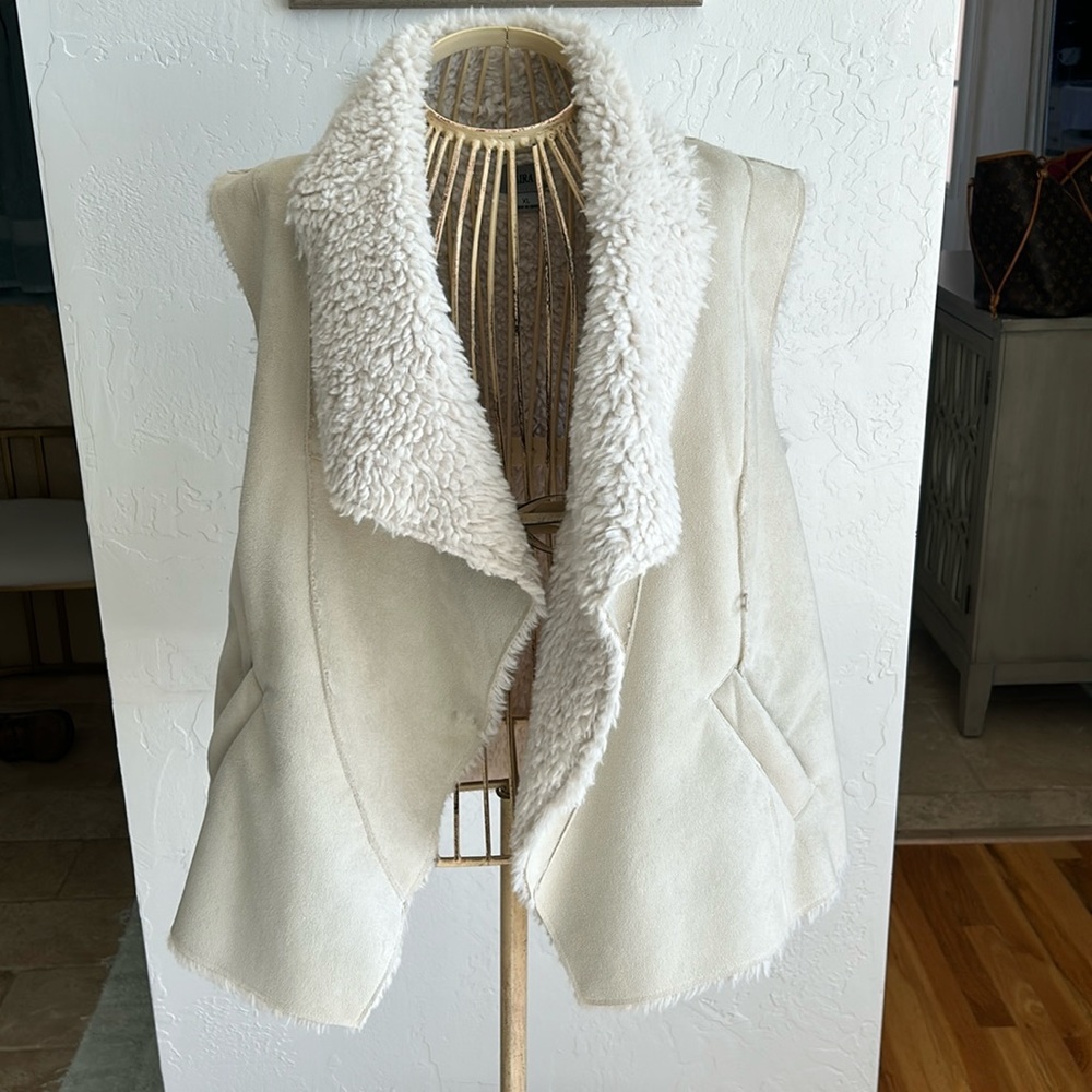 Cream colored vest with faux Schierling inside and faux suede leather outside.